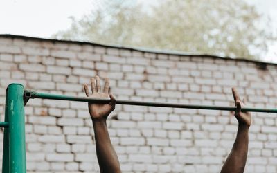 Close-up on hands gripping the floor during a bodyweight exercise.