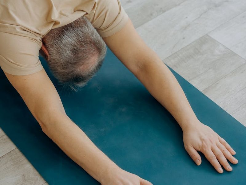 Man focusing before starting an exercise routine in a calm setting.